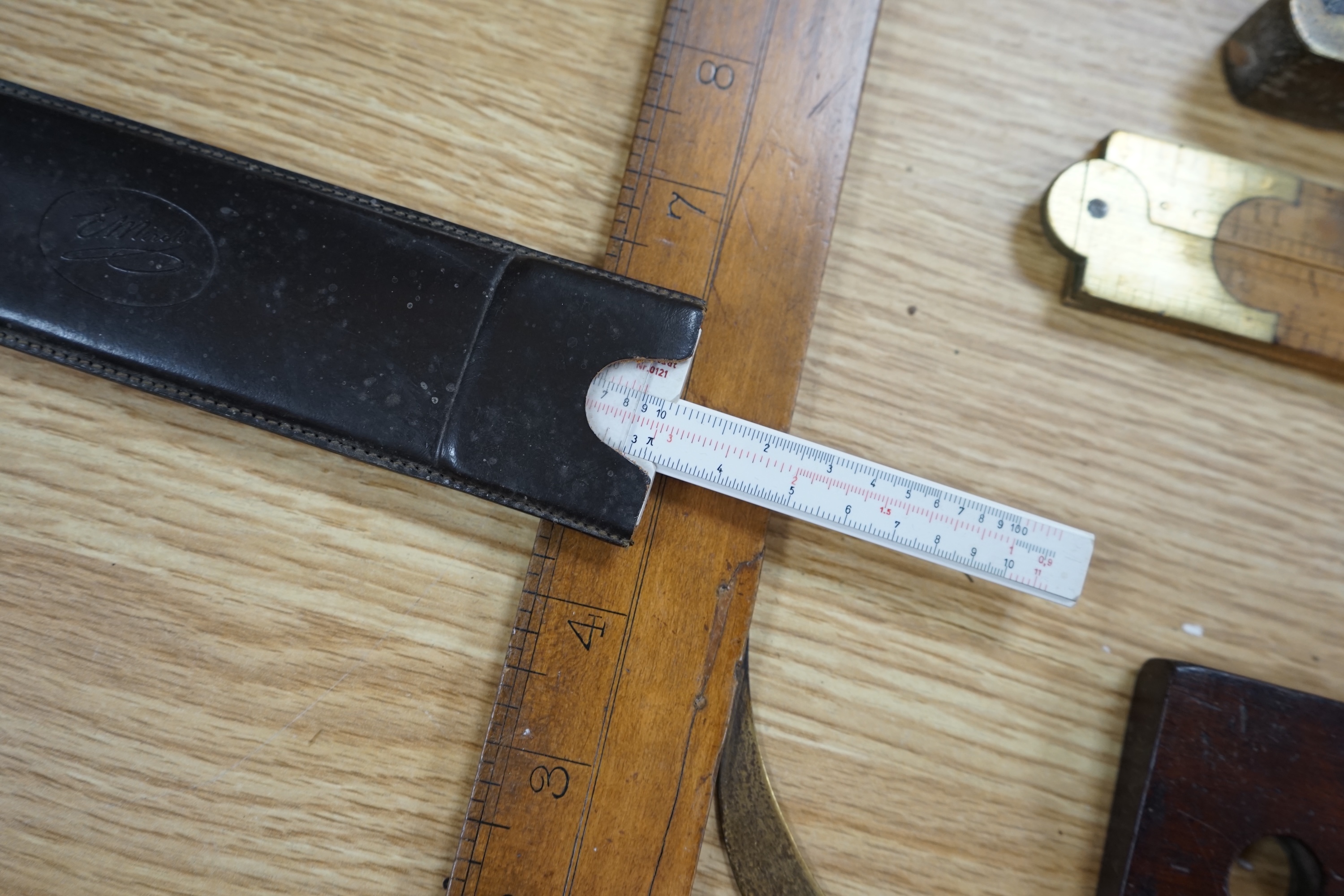 A collection of 19th and 20th century drawing instruments, including; levels, rulers, a set square etc. longest 79cm. Condition - variable, mostly fair to good